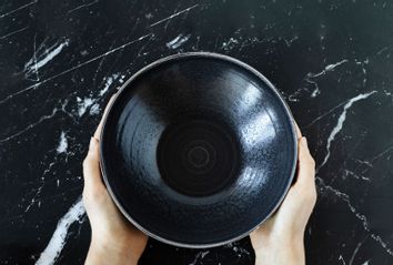 Woman's hands holding an empty dish bowl