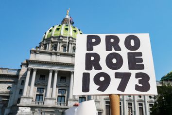 A protester holds a placard in front of the Pennsylvania State Capitol during the Rally for Reproductive Rights.