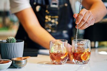 Bartender mixing cocktails in bar