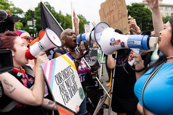 Pro-choice and pro-life activists shout each other down with megaphones outside of the U.S. Supreme Court