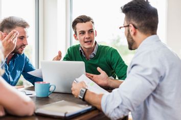 Young professionals arguing in office