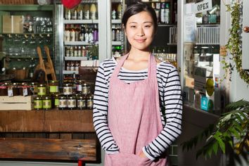 Female shop keeper wearing an apron