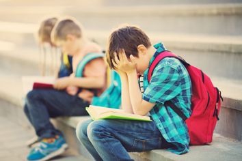 Child frustrated reading a book