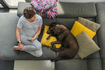 Woman sitting on the couch with her dog