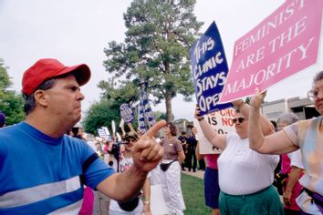 A man scowls as he confronts a pro-choice demonstrator outside a pregnancy center in Little Rock.