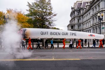 Cannabis activists carry a blow-up joint on 17th Street NW, outside of the Eisenhower Executive Office Building 