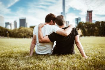 Gay couple sitting outside together