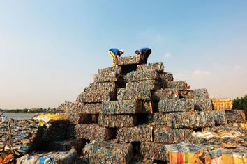 Egyptian volunteers arrange sacks with plastic waste to build the world's largest plastic pyramid on September 17, 2022 in Giza, Egypt.