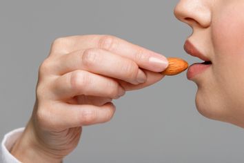 Woman eating an almond