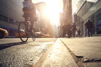Rush hour with taxis, bicyclists and people