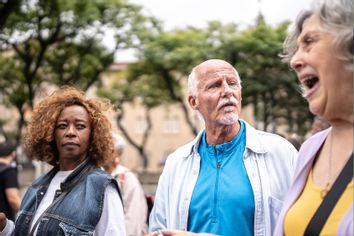 Senior woman screaming and her friends looking surprised