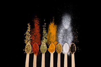 Spices herbs on wooden spoons
