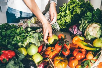 Woman takes out fresh organic vegetables