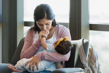 Mom kissing baby's hand