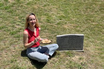Rosie Grant sitting by the gravestone of Annabell Gunderson