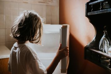 A child looks into an empty fridge