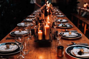 Lit candles on a set dining table