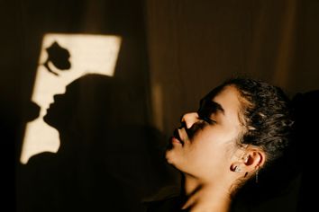 Portrait of a young woman, with the shadow of a rose