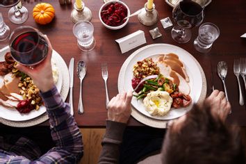 Overhead of two men eating holiday meal