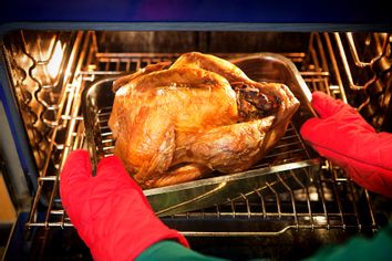 Freshly roasted turkey with stuffing coming out of the oven
