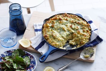 Meal with pan of macaroni cheese and salad leaf