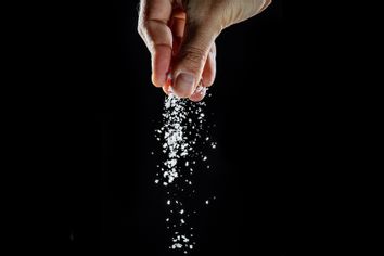 Male hand sprinkling salt