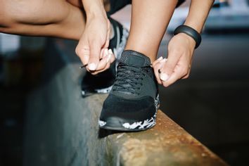 Woman tying running shoes