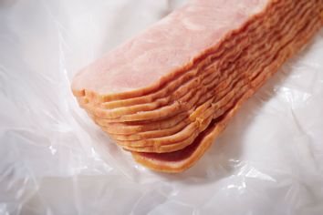 Sliced raw turkey bacon
