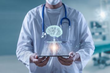 Doctor holding tablet showing brain human and body