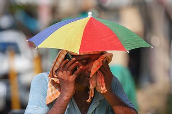Heat Wave Varanasi India Man Umbrella Hat