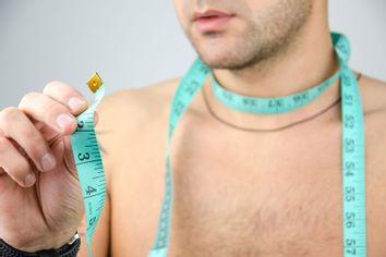 Man measuring his neck