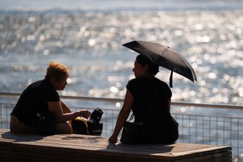 NYC Woman using umbrella during heat wave