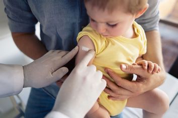 Child getting bandaid vaccine doctor