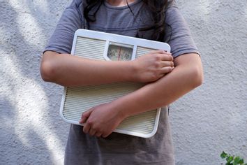 Teenager holding a scale