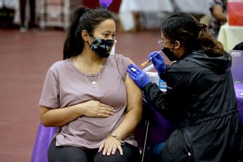 Pregnant woman getting covid-19 vaccine booster shot