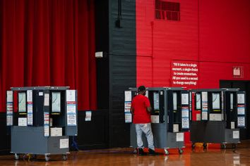 A voter casts his ballot in a polling place on Election Day in College Park, Georgia