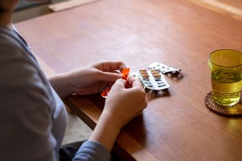 woman taking medicine at home