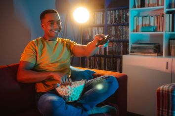 Young man watching TV at night