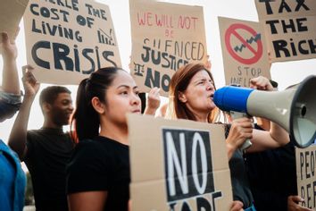 Protesters holding banners signs rally 2186413575