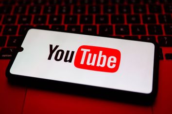 YouTube logo is displayed on a mobile phone