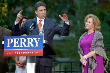U.S. Republican presidential candidate Perry speaks as his wife Anita looks on in Greenland
