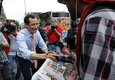 Former U.S. Congressman and New York City mayoral candidate Anthony Weiner greets commuters during a campaign event in New York