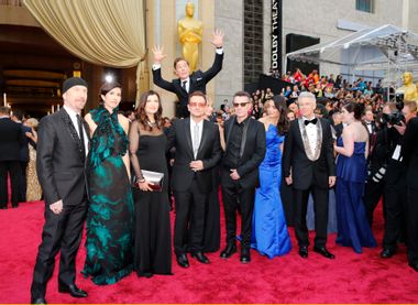 Actor Benedict Cumberbatch jumps behind U2 at the 86th Academy Awards in Hollywood