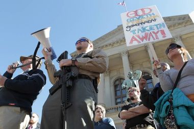 Rugh holding AR-15 rifle during the Guns Across America rally at the State Capitol in Atlanta