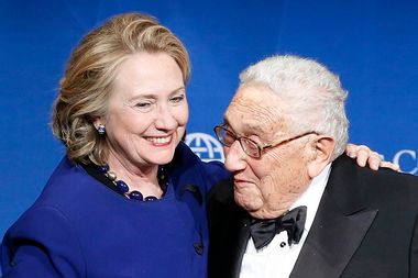 Clinton puts her arm around Kissinger after he presented her with a Distinguished Leadership Award from the Atlantic Council in Washington