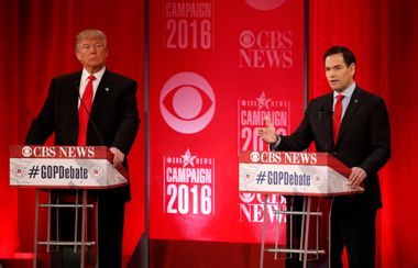 Republican U.S. presidential candidate Trump listens as Rubio speaks at the Republican U.S. presidential candidates debate sponsored by CBS News and the Republican National Committee in Greenville