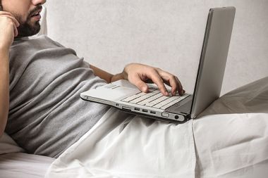 Man in Bed with Computer
