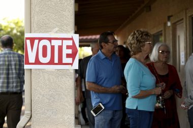 People wait to vote in the U.S. presidential primary election at a polling site in Arizona