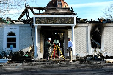 Security officials investigate the aftermath of a fire at the Victoria Islamic Center mosque in Victoria, Texas