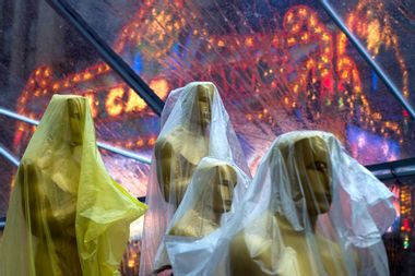 Covered Oscars statues rest under a tent, to guard against rain, along the red carpet ahead of the 86th Academy Awards in Hollywood, California
